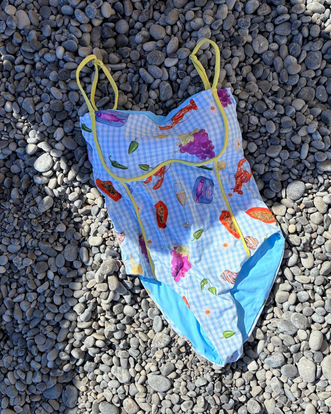 Models showcasing our Miranda No. 2 Black and White One-piece with a front and back cut out and Cassie No. 2 Butter Yellow & Pink One-piece with front and back cut out.