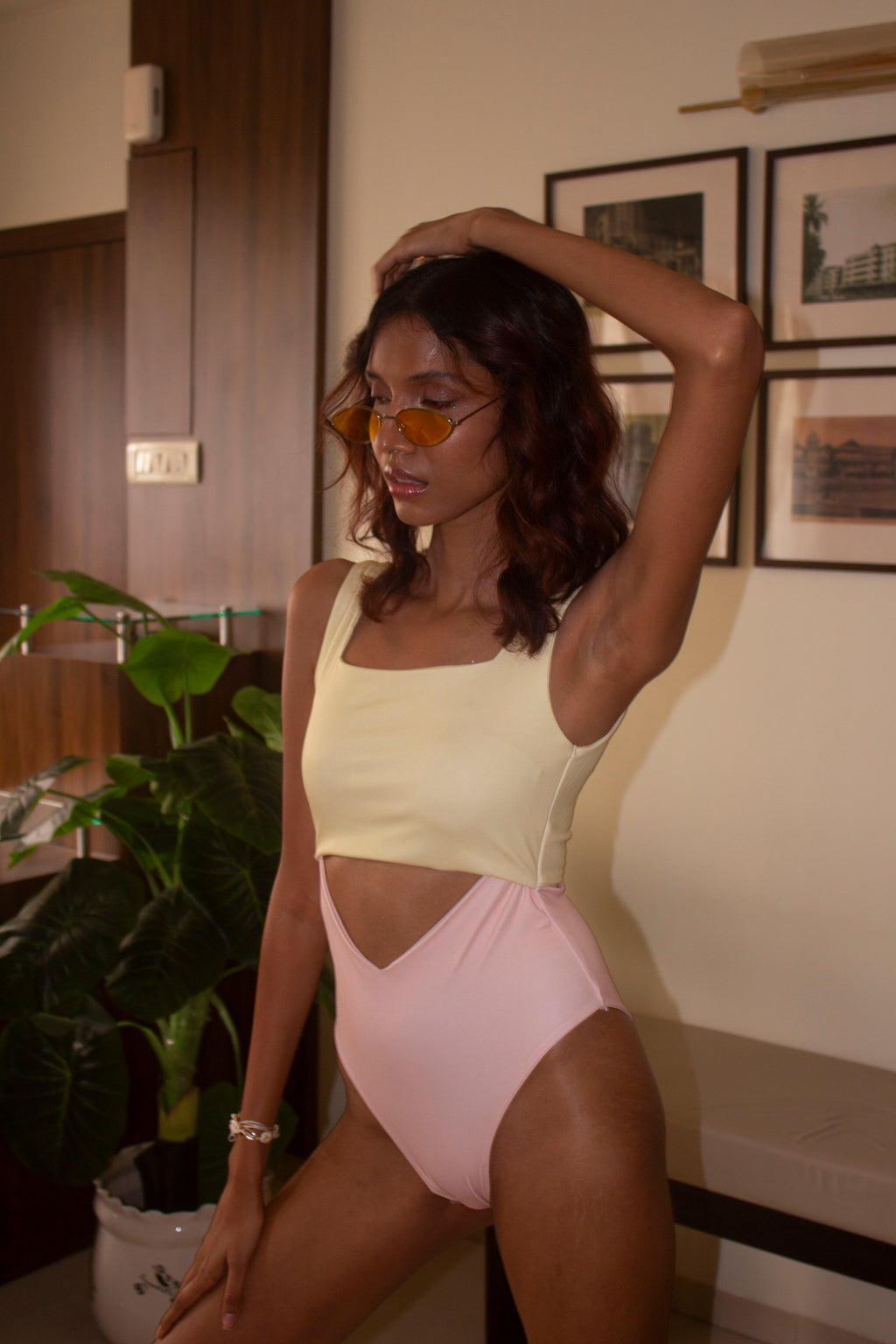 Close-up view of our butter yellow and light pink one-piece with front and back cut outs