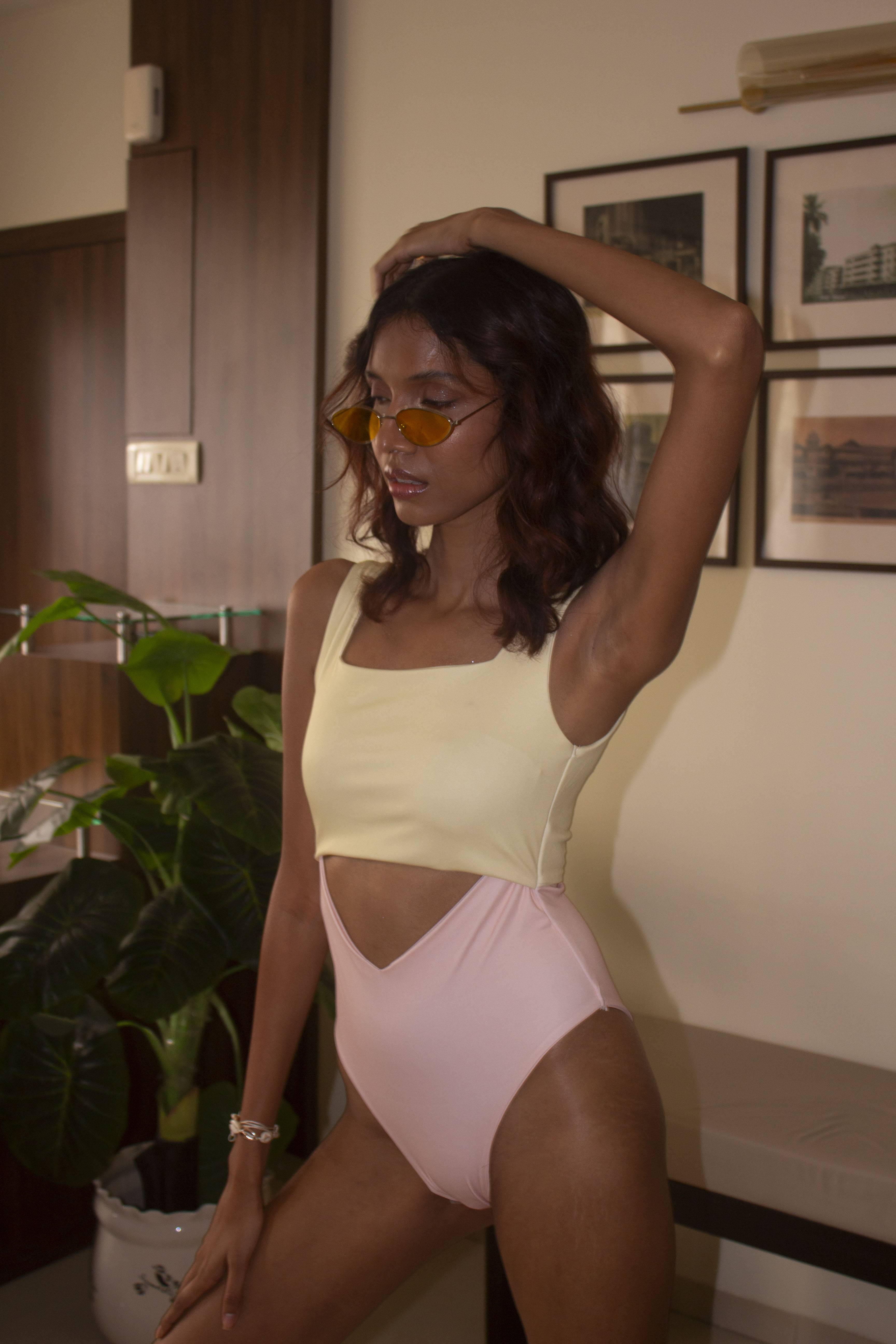 Close-up view of our butter yellow and light pink one-piece with front and back cut outs