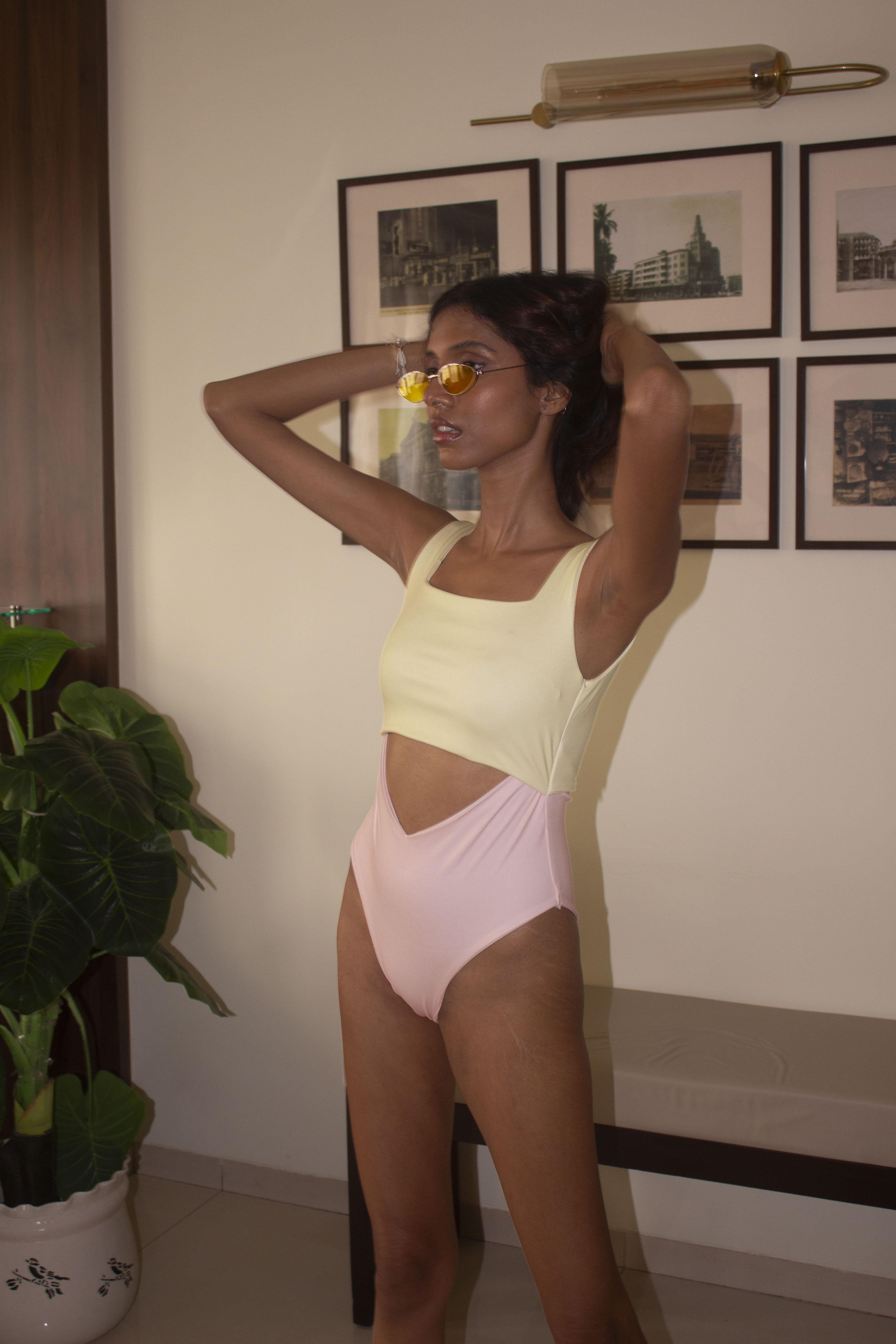 Front, full view of our butter yellow and light pink one piece with front and back cut outs